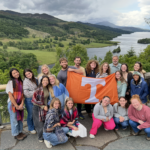 Students smiling with Tennessee flag